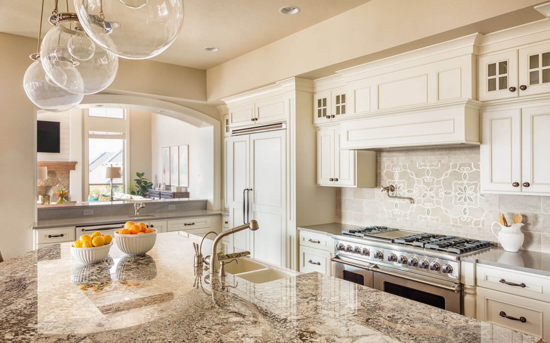 Modern kitchen with polished granite countertops showcasing natural stone patterns, complemented by sleek stainless steel appliances and warm under-cabinet lighting.